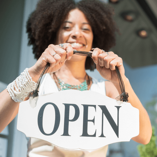 business owner holding open sign