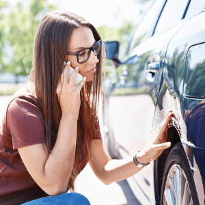 woman looking at scratched car